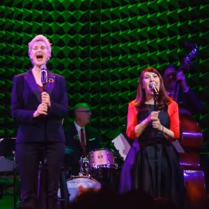 Review: JANE LYNCH & KATE FLANNERY Bring the Glee to Their Office Christmas Party In…