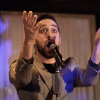 Video: Watch George Abud Sing 'Perfection' from LEMPICKA Video