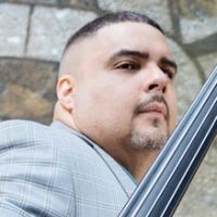 GRAMMY-Nominated Bassist Carlos Henriquez Presents Monk Con Clave With The Jazz At Li Interview