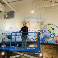 Lia Ali paints one of  the largest murals in the history  of Long Island