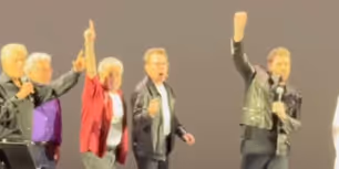 Video: John Travolta Surprises Fans as 'Danny Zuko' at GREASE Sing-Along