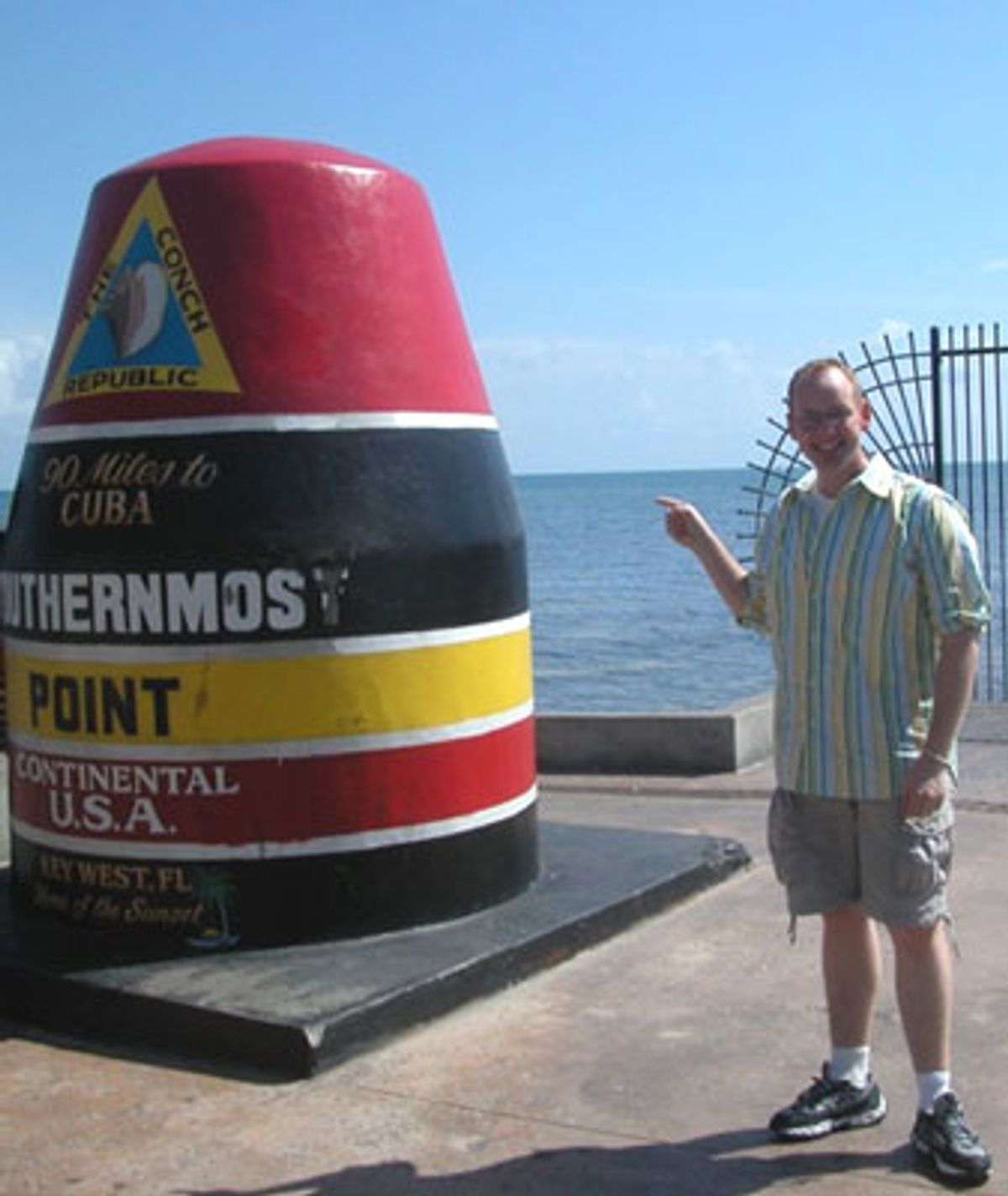 Jamie at The Southernmost Point in the Continental USA (Jamie stood a few feet away and cropped out the girl on the other side of this monument, so he wouldn't have to stand in a long line to have his picture taken with a big metal dingy).  at 