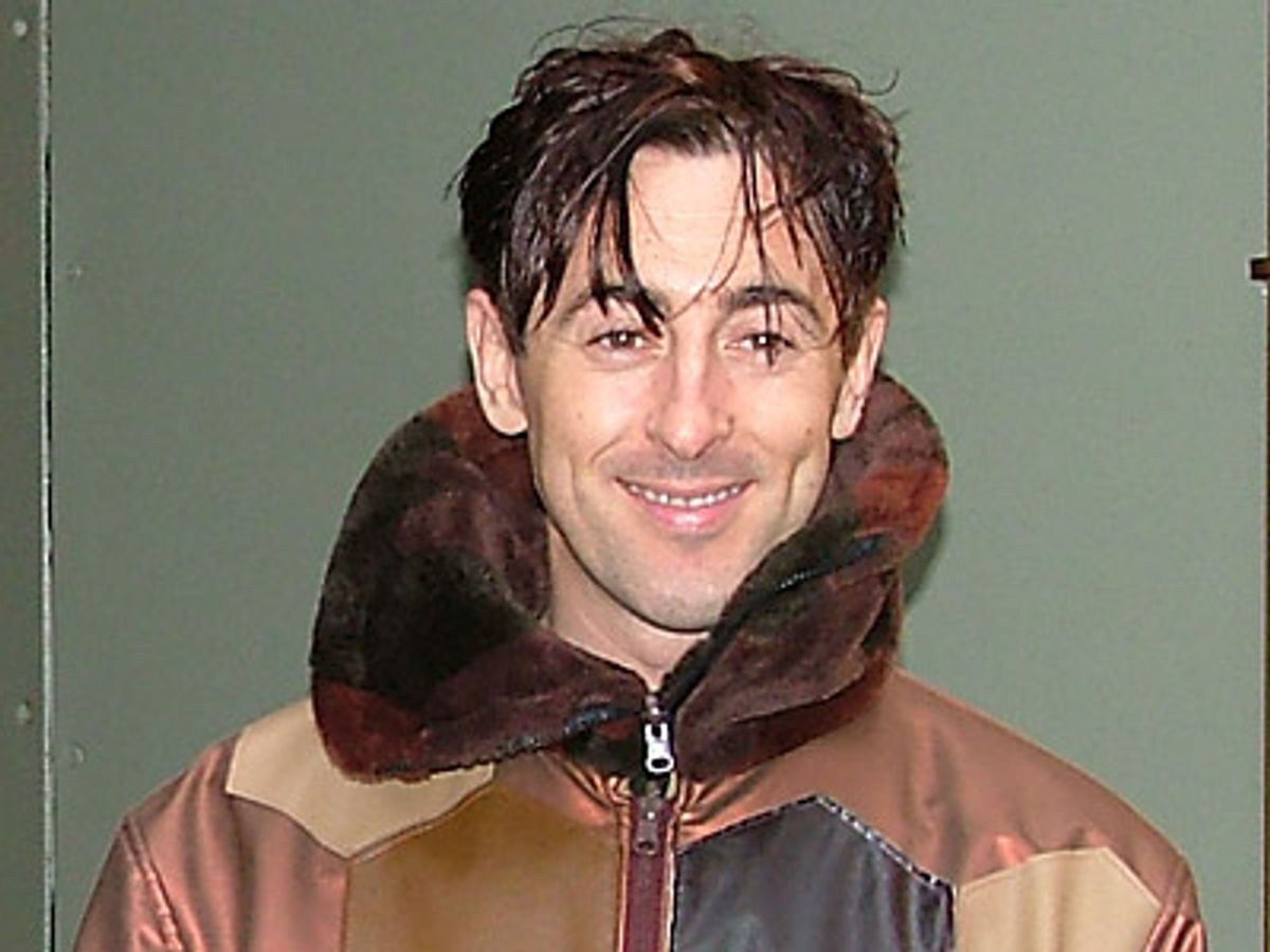 Alan Cumming stops for a smile  at 