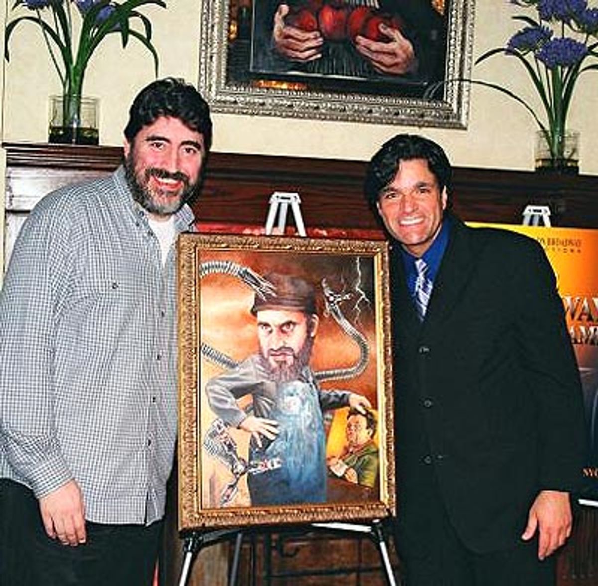 A beaming Alfred posing with his painting along with Dale Badway at 