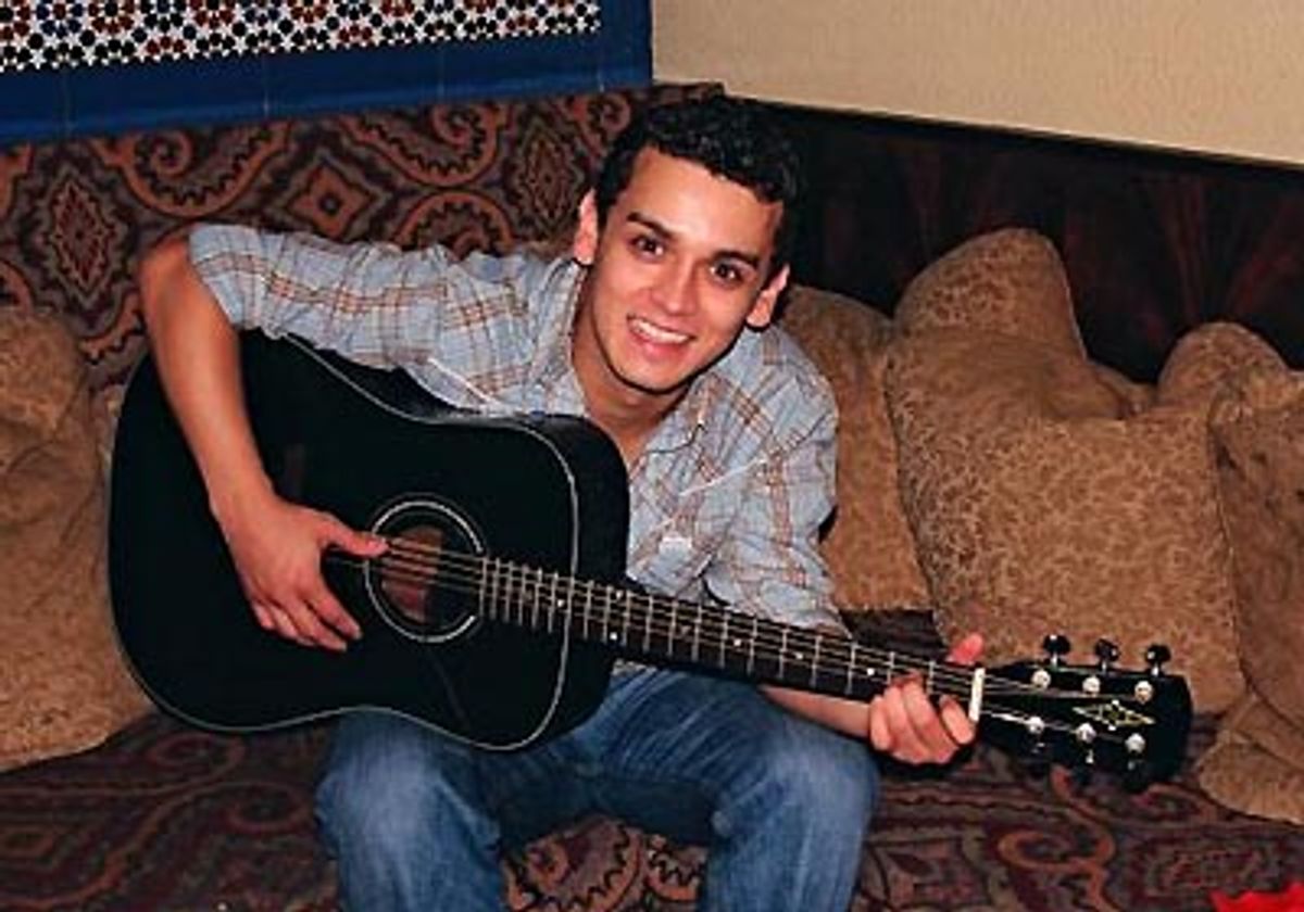 
Michael Longoria poses with his guitar  at 