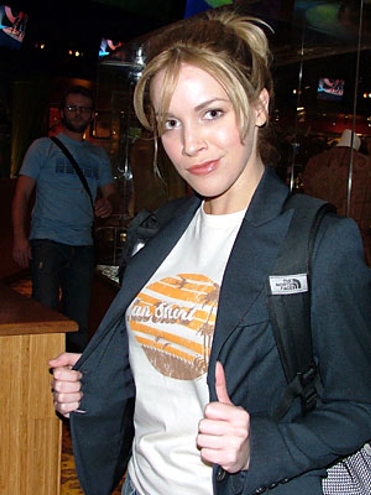 Sara Chase shows off her tan shirt at 