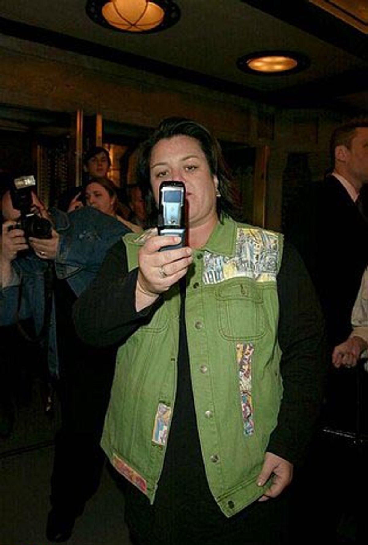 Rosie O'Donnell taking photos with her cell phone at 