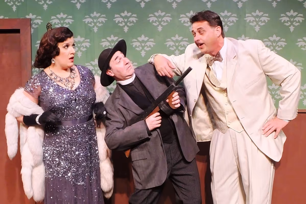 Comic antics ensue in Cole Porter’s musical comedy Anything Goes as Lord Evelyn Oakley (Tom Pagano of Clinton Twnp.) mixes up his American phrases to Moonface Martin (Michael A. Gravame of Detroit) as Reno Sweeney (Danielle Caralis of Birmingham) looks on in delight. Comic antics ensue in Cole Porter’s musical comedy Anything Goes as Lord Evelyn Oakley (Tom Pagano of Clinton Twnp.) mixes up his American phrases to Moonface Martin (Michael A. Gravame of Detroit) as Reno Sweeney (Danielle Caralis of Birmingham) looks on in delight.