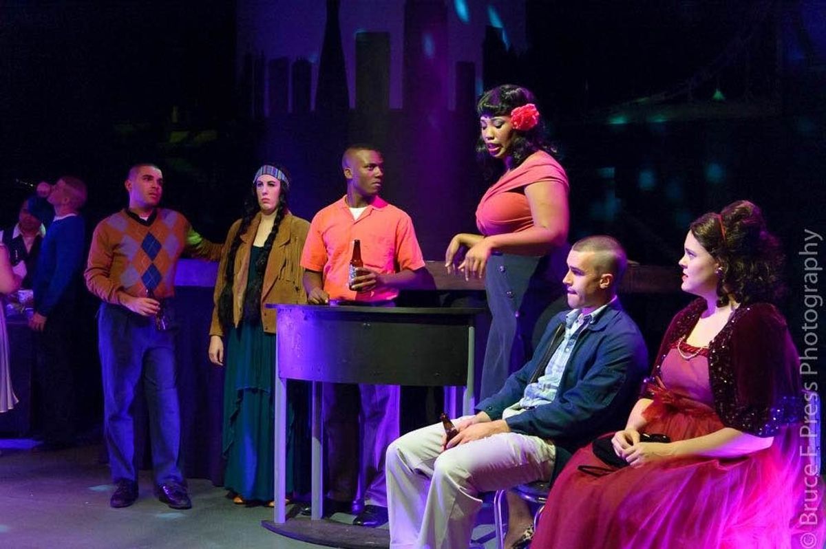 The cast of Dogfight unwinds at a party onstage. The cast of Dogfight unwinds at a party onstage.