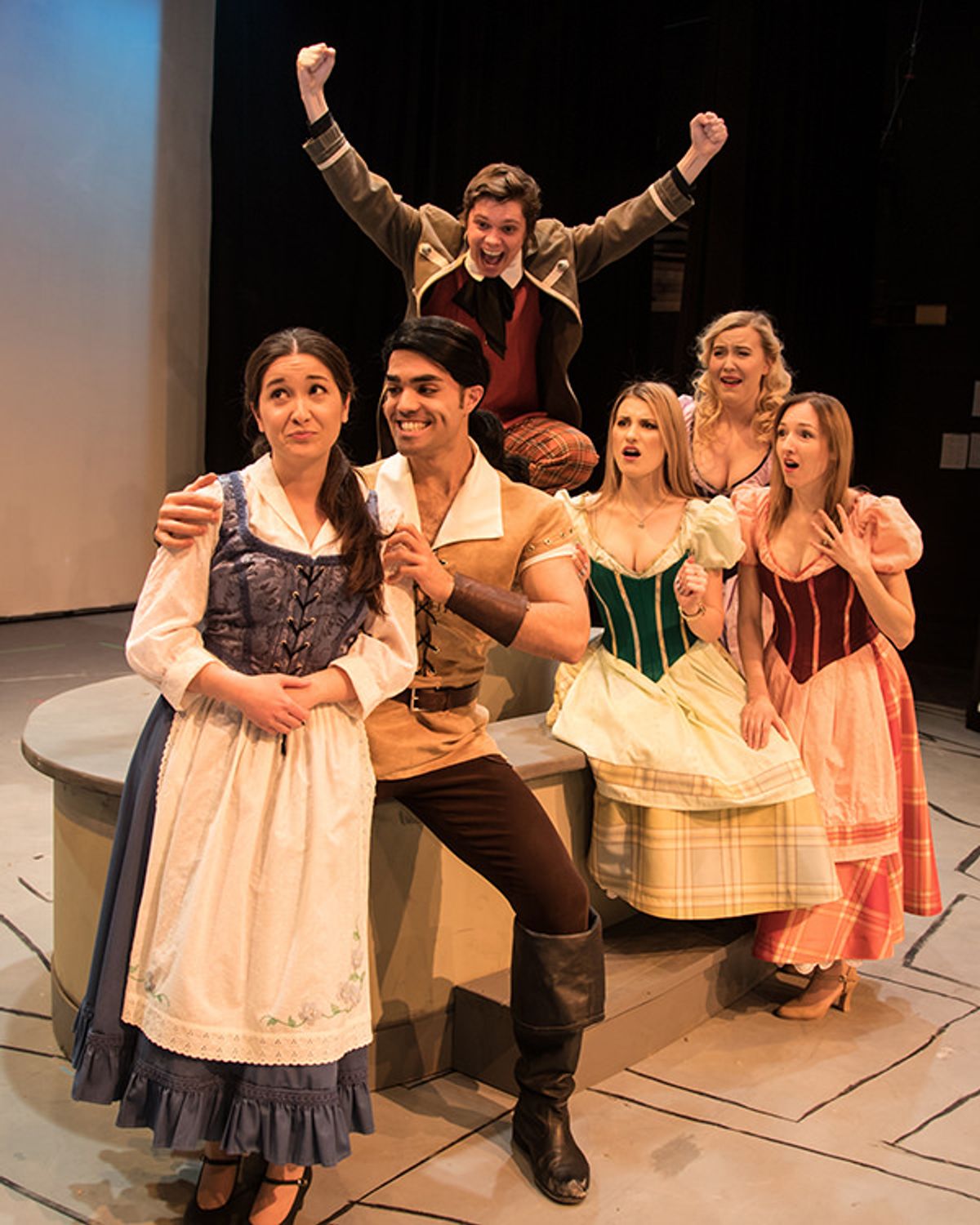 Belle (Laura Fujita) reacts with dismay as Gaston (Rob Murphy) attempts to impress her with his overt manly charm much to the delight of his sidekick Lefou (Kyle Humbly); meanwhile the Silly Girls,  Shannon Post, Kathryn Fraser and Nicole Daniel react in horror.