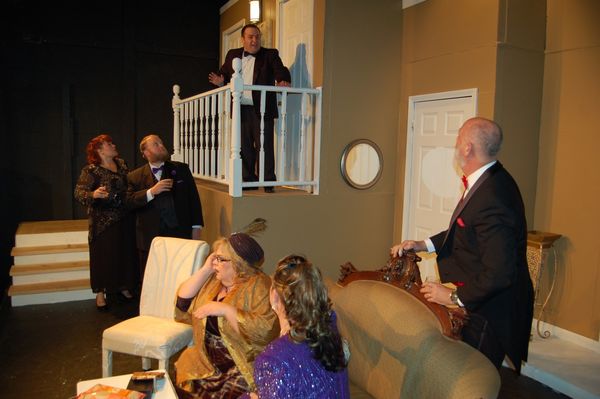 Ken (on the balcony) continues his web of lies in order to prevent his secret from coming out at Charley and Myra's anniversary party. 1