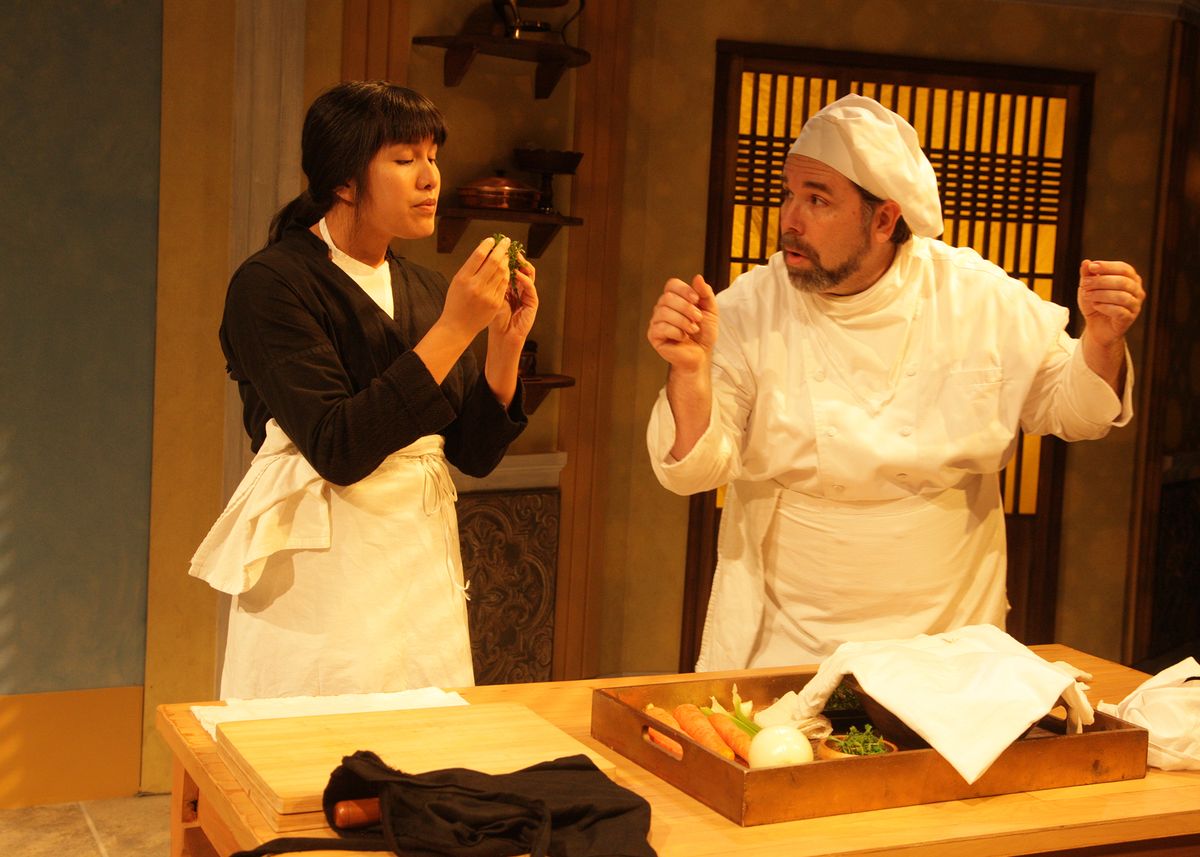 Hannah Mariah as Thúy and Casey Long as Guillaume in the rolling world premiere of "Colonialism is Terrible, But Phở is Delicious," playing March 31 - April 30, 2023 at Better Aitken theater arts Center on the Cripe Stage. Written by Dustin H. Chinn; Directed by Oánh Nguyễn. Photo by Doug Catiller, True Image Studio. Hannah Mariah as Thúy and Casey Long as Guillaume in the rolling world premiere of "Colonialism is Terrible, But Phở is Delicious," playing March 31 - April 30, 2023 at Better Aitken theater arts Center on the Cripe Stage. Written by Dustin H. Chinn; Directed by Oánh Nguyễn. Photo by Doug Catiller, True Image Studio.