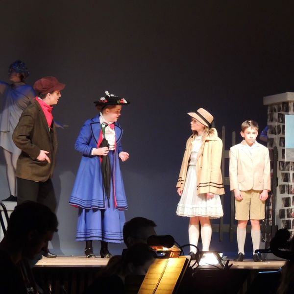 Bert (Michael Florio), Mary Poppins (Christina McBride), Jane (Lindsey Mousch), and Michael (Christopher Miller) at the gates of the park before "Jolly Holiday." 1