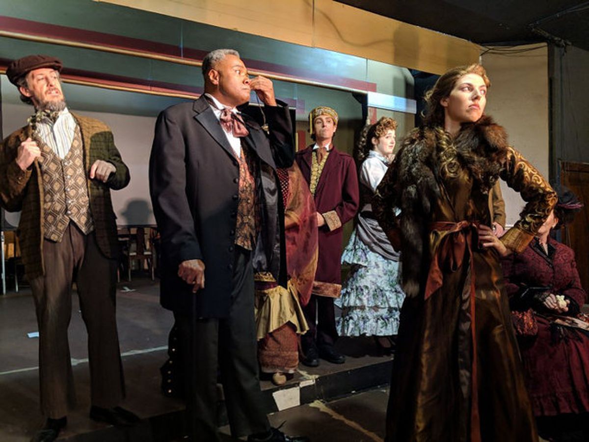 Miss Nutting, Please!: Darryl Maximilian Robinson as The Chairman Mr. William Cartwright is displeased with the show of temperament by Drood Player Sarah Myers ( attired in fur ) in her offstage persona as Miss Alice Nutting before the rest of the cast in the 2018 Saint Sebastian Players of Chicago Revival of Rupert Holmes' 'The Mystery of Edwin Drood'. Photo by Eryn Walanka. Miss Nutting, Please!: Darryl Maximilian Robinson as The Chairman Mr. William Cartwright is displeased with the show of temperament by Drood Player Sarah Myers ( attired in fur ) in her offstage persona as Miss Alice Nutting before the rest of the cast in the 2018 Saint Sebastian Players of Chicago Revival of Rupert Holmes' 'The Mystery of Edwin Drood'. Photo by Eryn Walanka.