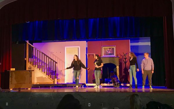 Students playing Jane, Michael, Miss Andrews, and Winifred rehearsing a scene.  1