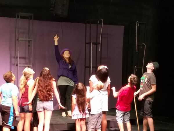 Maggie Toner as Willy Wonka leads the Golden Ticket Winners into his famous chocolate factory. 1