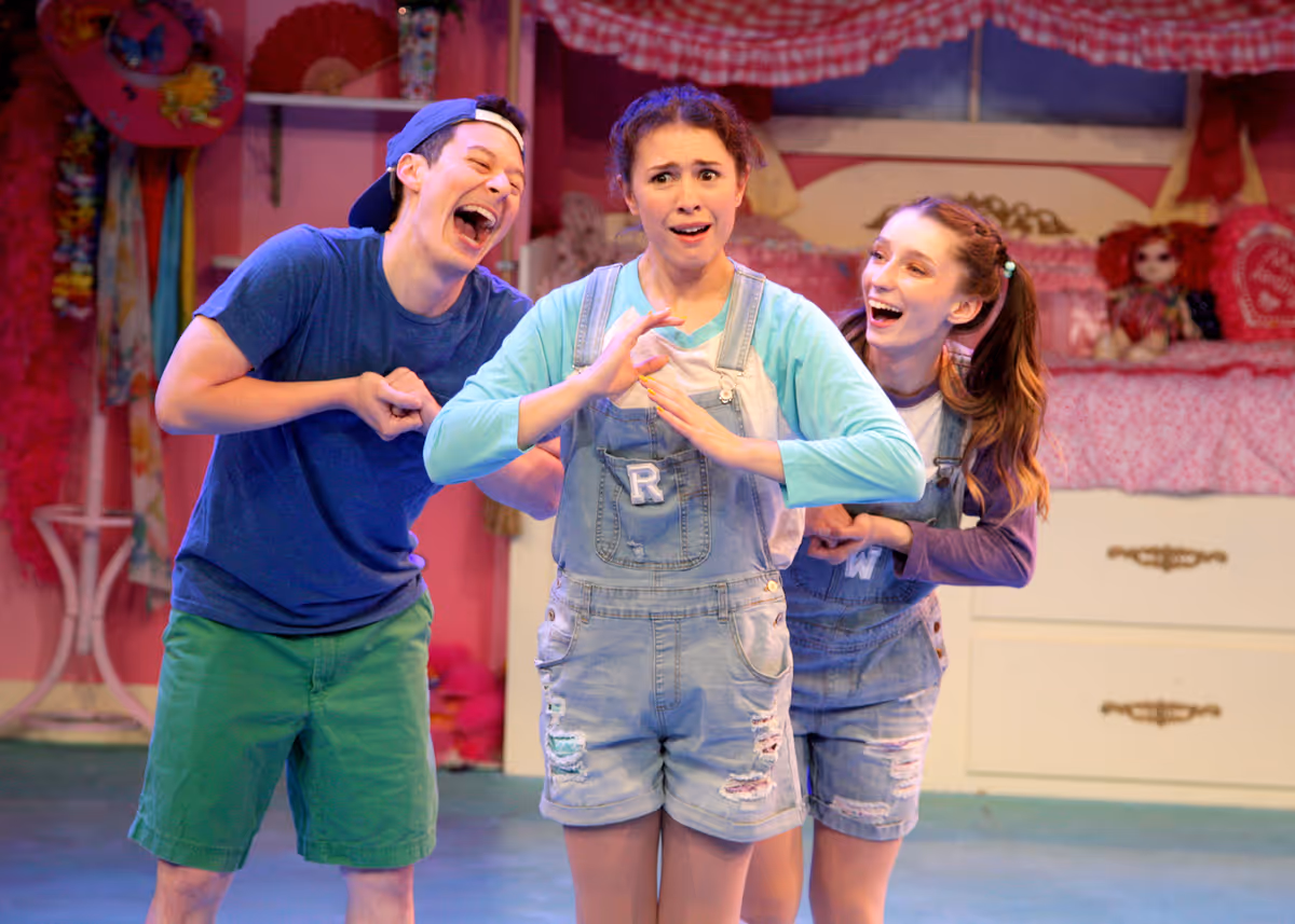 Matt Takahashi as Lionel, Emily Abeles as Rhonda, and Alyssa Corella as Wanda in Chance Theater's TYA production of "Fancy Nancy, The Musical". Playing through June 19, 2022, this musical adaptation of the popular book series has book and lyrics by Susan DiLallo, music and lyrics by Danny Abosch, and is directed by Laura M. Hathaway and music directed by Robyn Manion. Photo by Doug Catiller.