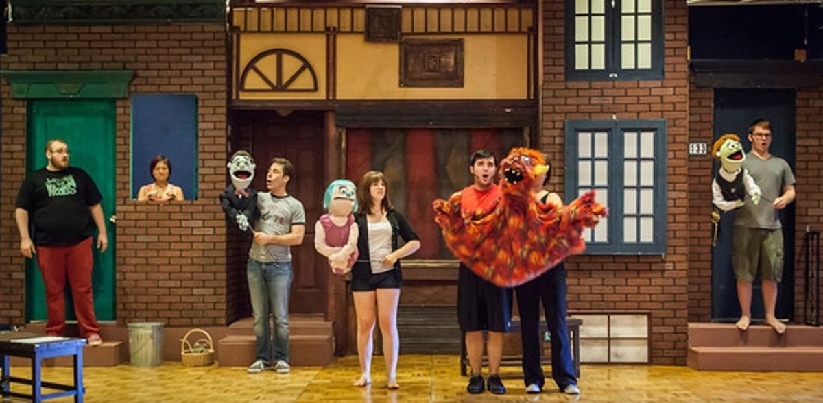 The Portland cast of Avenue Q on set.
Jonathan Quesenberry (Brian); Sarah Kim (Christmas Eve - in window); Norman Wilson (Rod); Meghan McChandles (Kate Monster); James Sharinghousen (Trekkie Monster) with Chrissy Pettit and Bryan Kinder (Princeton)
Photo by David Kinder The Portland cast of Avenue Q on set.
Jonathan Quesenberry (Brian); Sarah Kim (Christmas Eve - in window); Norman Wilson (Rod); Meghan McChandles (Kate Monster); James Sharinghousen (Trekkie Monster) with Chrissy Pettit and Bryan Kinder (Princeton)
Photo by David Kinder