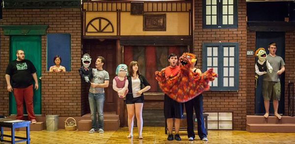 The Portland cast of Avenue Q on set.
Jonathan Quesenberry (Brian); Sarah Kim (Christmas Eve - in window); Norman Wilson (Rod); Meghan McChandles (Kate Monster); James Sharinghousen (Trekkie Monster) with Chrissy Pettit and Bryan Kinder (Princeton)
Photo by David Kinder 2