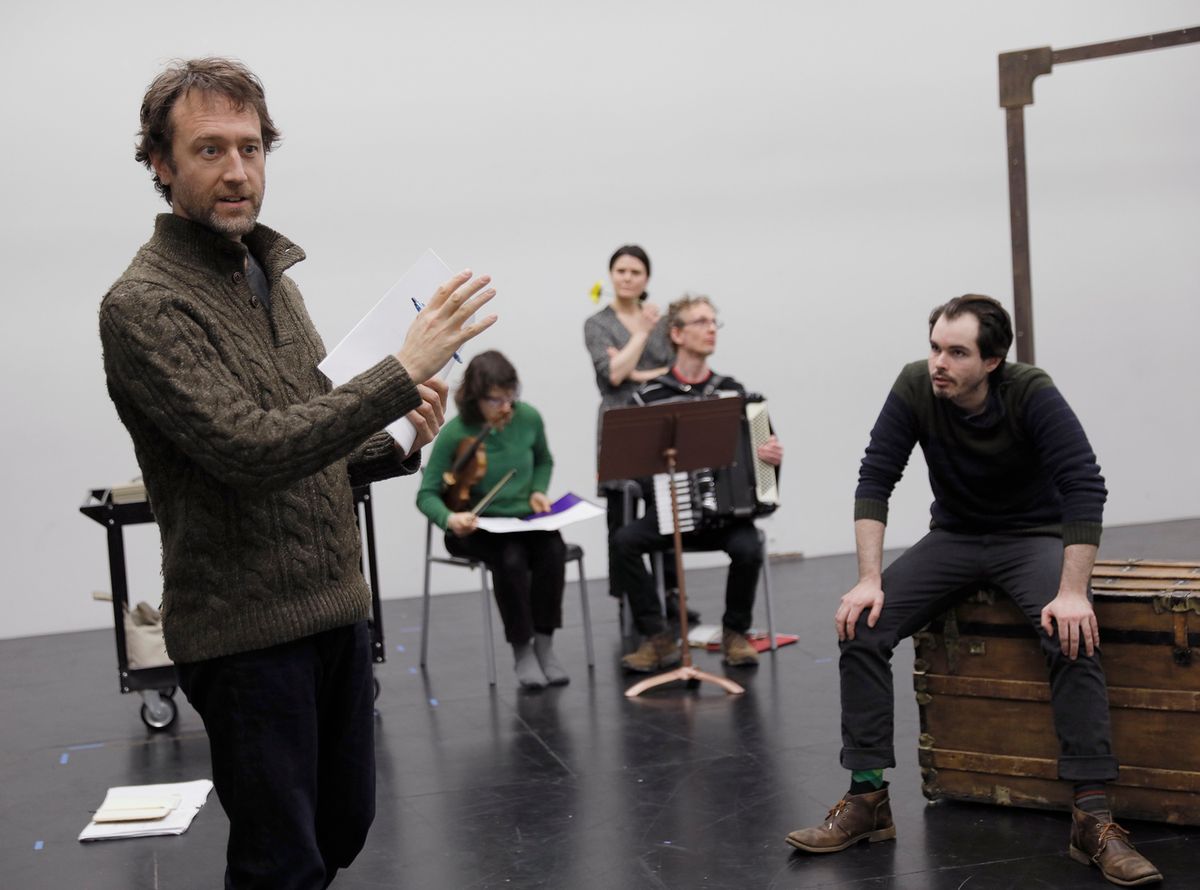 Composer BRENT ARNOLD discusses stagins with the musicians and ensemble of THE MASTER & MARGARITA.