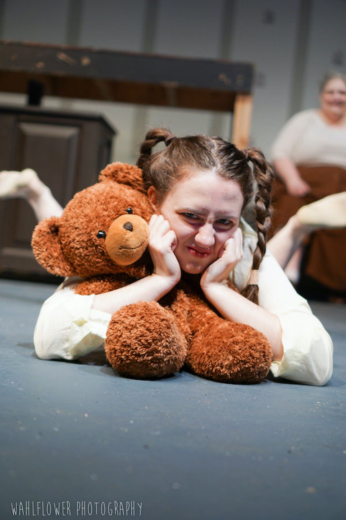 Little Sally played by Emma Muller helps to narrate Urinetown. This show is a hysterically intelligent musical that makes fun of itself as a musical. Photo credit Wahlflower Photography.