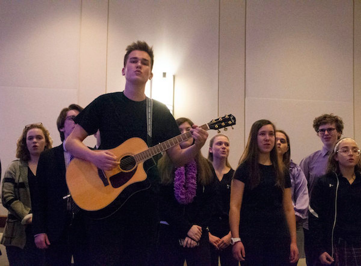 A rehearsal shot featuring Mike Barkasy as Tommy/Narrator on guitar