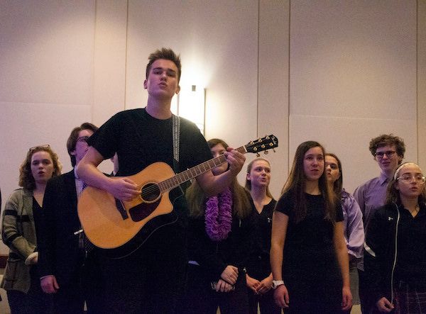 A rehearsal shot featuring Mike Barkasy as Tommy/Narrator on guitar 1