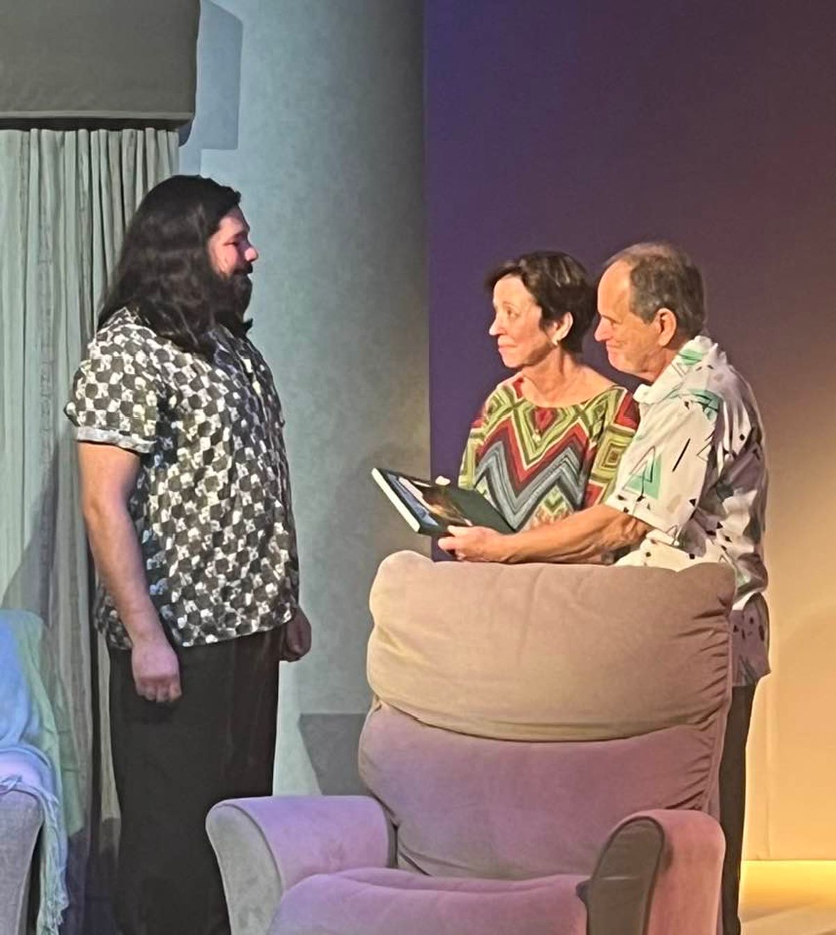 Experience the laughs, groans, and tears as photographer Larry tries to finish his ?project? about his family. Pictured L-R: David Burkhart, Lilli Bassett, and Terry Veal. Experience the laughs, groans, and tears as photographer Larry tries to finish his ?project? about his family. Pictured L-R: David Burkhart, Lilli Bassett, and Terry Veal.
