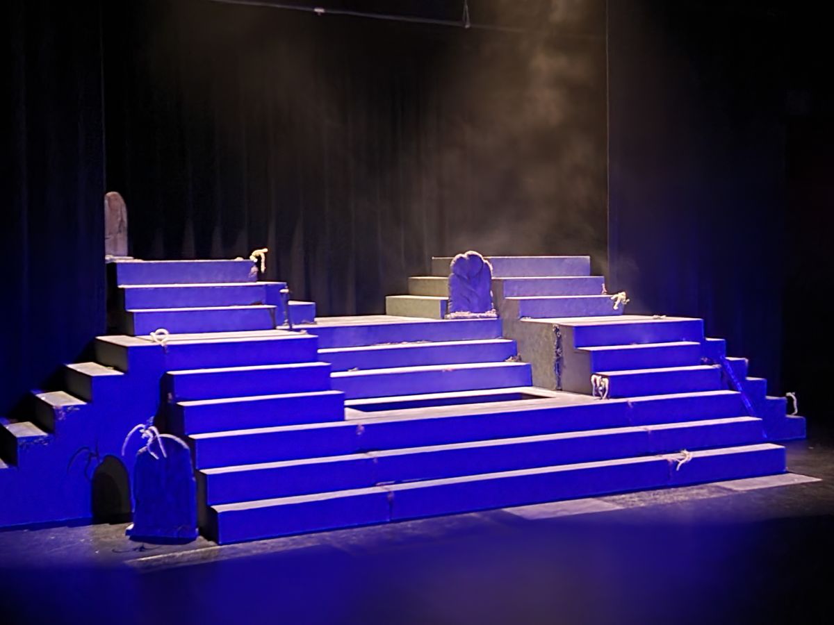 The set combining the Midwestern set cemetery of Spoon River with a Greek style of storytelling.