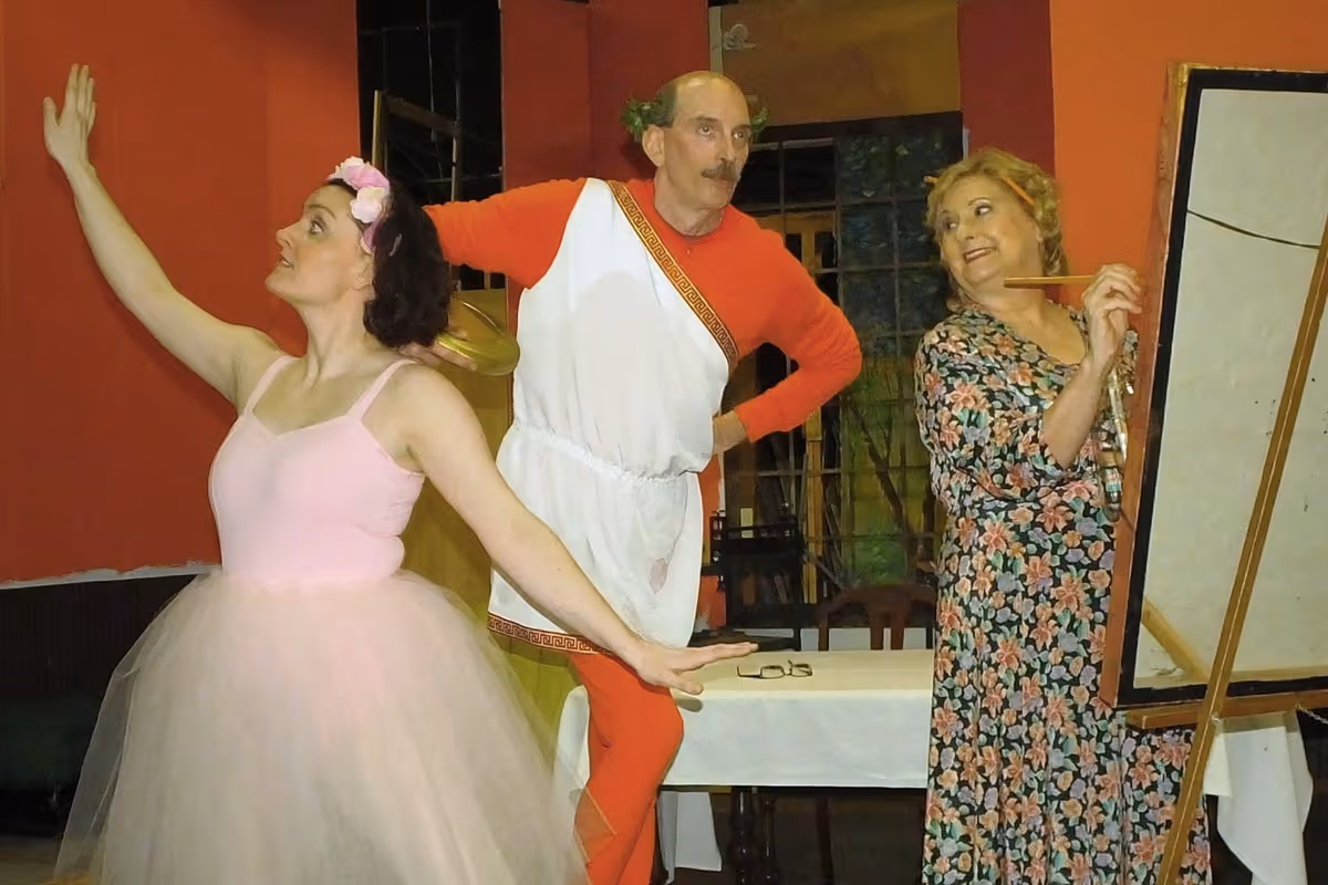 Just a normal typical day at the Sycamore house filled with ballet lessons, painting, snakes, xylophones and fireworks. Essie (Kathleen Duffy, pictured left), Mr. DiPina (Steve Roberts, pictured center) and Penny Sycamore (Sue Chekaway) star in this charming comedy; You Can’t Take It With You. Just a normal typical day at the Sycamore house filled with ballet lessons, painting, snakes, xylophones and fireworks. Essie (Kathleen Duffy, pictured left), Mr. DiPina (Steve Roberts, pictured center) and Penny Sycamore (Sue Chekaway) star in this charming comedy; You Can’t Take It With You.