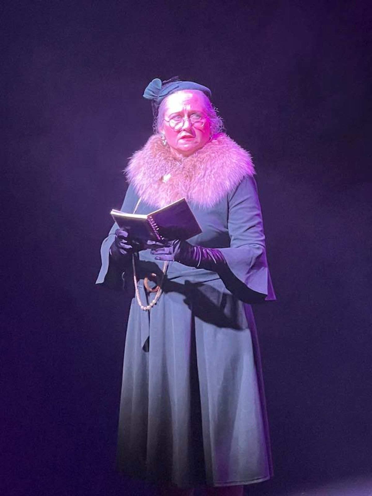 Here, the reporter Adela has the latest news about the Lindbergh baby kidnapping. Pictured: Shawn Witcher as Adela. 