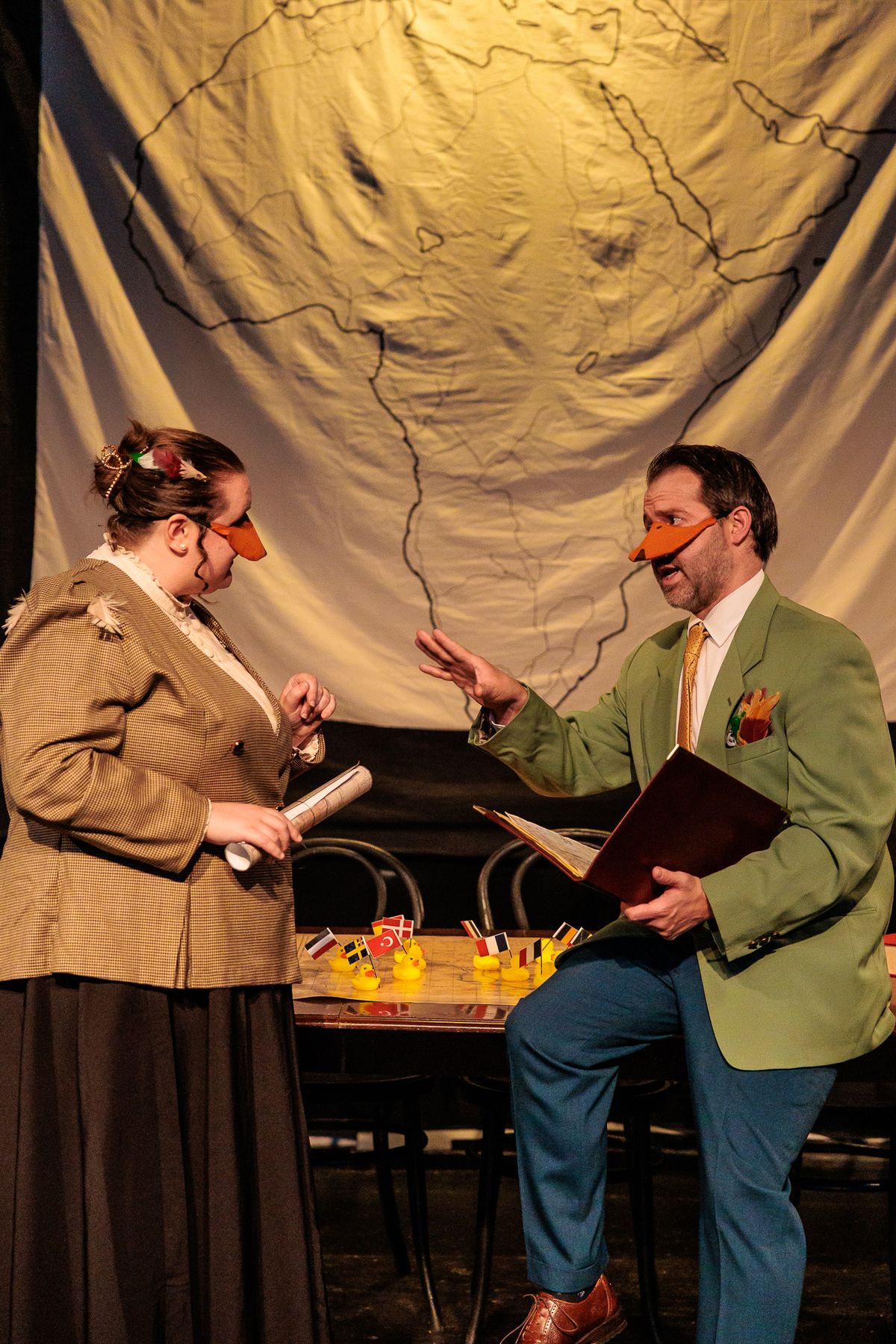 The Marquês de Penaquill (Hollie Pryor) listens to the drake-splaining Mr. Duck (Nate Speckman) in Heart of Duckness by A.J. Ditty. Photo by Kat Moraros Photography. The Marquês de Penaquill (Hollie Pryor) listens to the drake-splaining Mr. Duck (Nate Speckman) in Heart of Duckness by A.J. Ditty. Photo by Kat Moraros Photography.