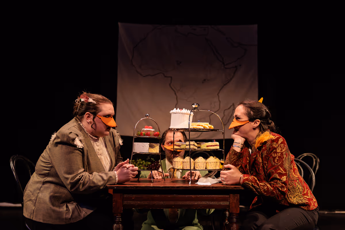 The Marquês de Penaquill (Hollie Pryor, left) faces off with King Leopold II (Allison McCall, right) while an anxious Mr. Duck looks on in Heart of Duckness by A.J. Ditty. Photo by Kat Moraros Photography. The Marquês de Penaquill (Hollie Pryor, left) faces off with King Leopold II (Allison McCall, right) while an anxious Mr. Duck looks on in Heart of Duckness by A.J. Ditty. Photo by Kat Moraros Photography.