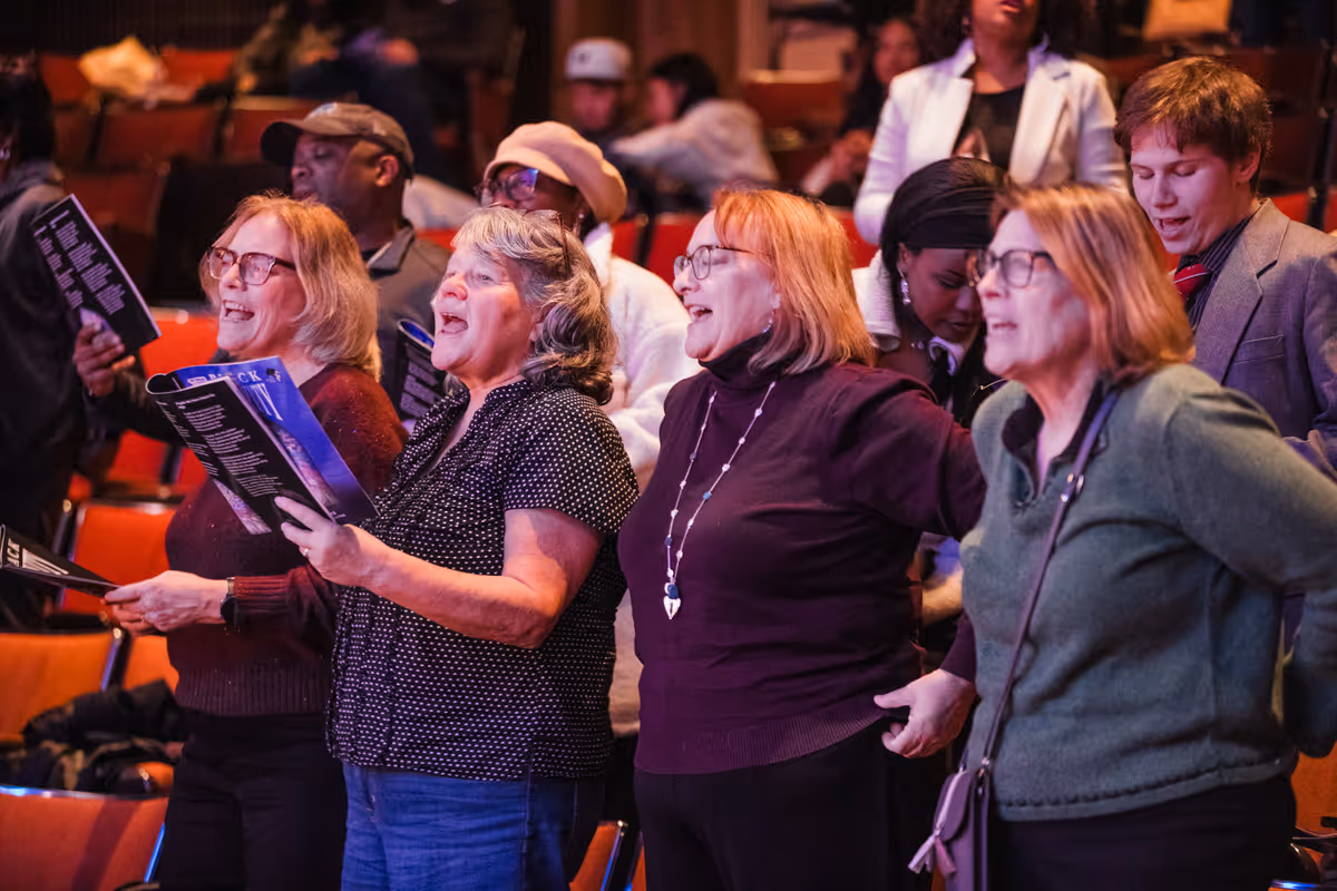 Audience members sing- along at Black Nativity. Photo by Joe Moore. Audience members sing- along at Black Nativity. Photo by Joe Moore.