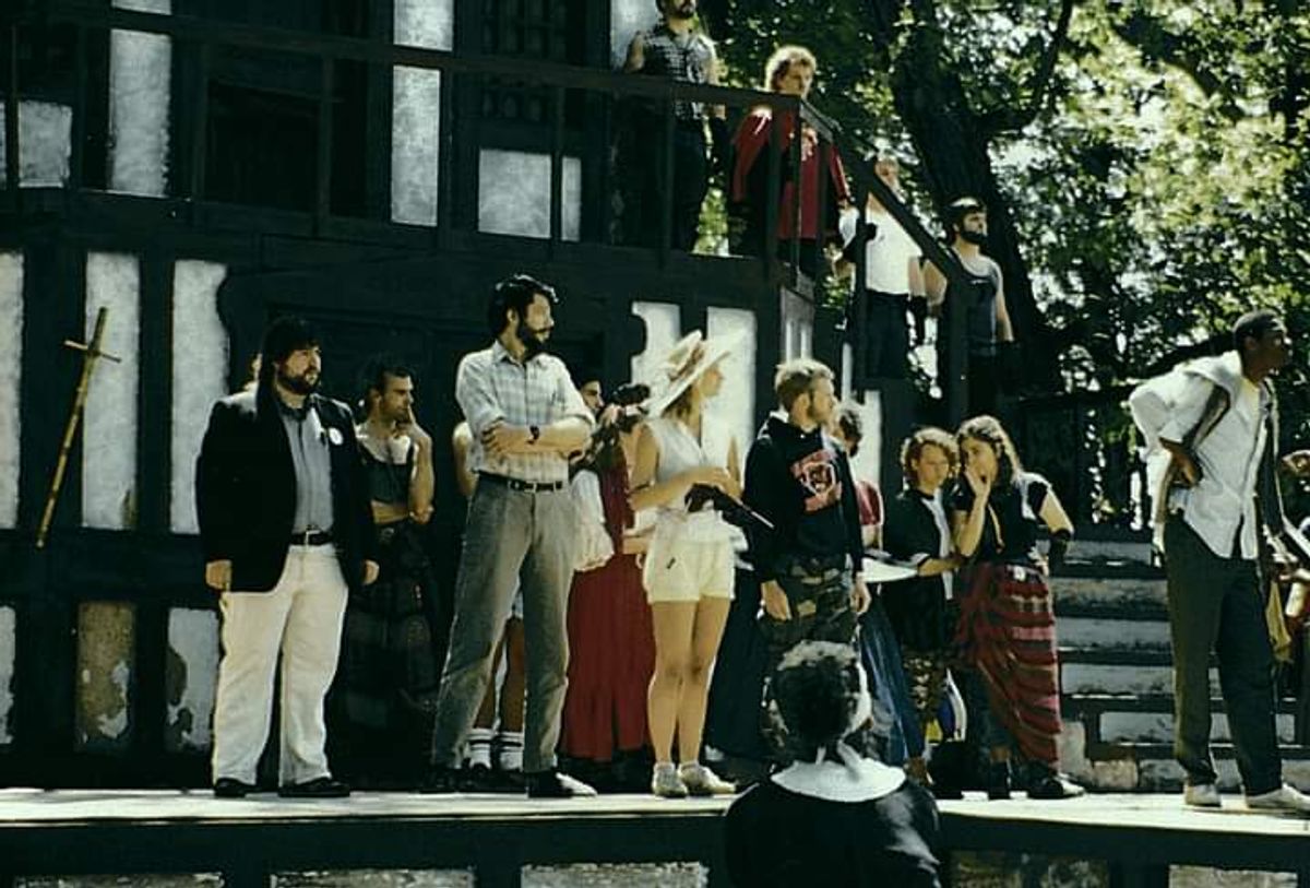 WHODUNIT?: Enjoying one of the best comedic roles of his early career on an outdoor Renaissance Festival Mainstage, future Excaliber Shakespeare Company of Chicago and Excaliber Shakespeare Company Los Angeles Archival Project Founder Darryl Maximilian Robinson ( seen on the far right amongst the group of  performers of The Court ) rehearses his Royal Court Member Role as His Eminence, Tomas de Torquemada, The Grand Inquisitor of Spain ( who is ultimately both a detective and a suspect ) in "Murder, They Quoth" the musical comedy mystery Grand Scenario upon The Mainstage of the 1986 14th Annual King Richard's Faire of Kenosha, Wisconsin.


