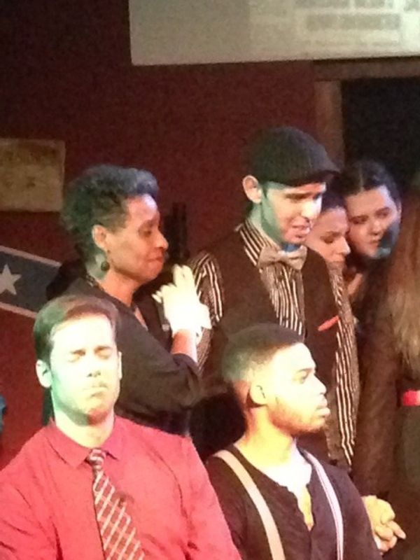The courtroom scene.  Mr.s Phagan's testimony.  Clockright from bottom left: Tim White as Hugh Dorsey, Leslie Silverman as Minnie McKnight, George Adamo as Frankie Epps, Rachel Nichols as Essie, Sara Den Bleyker as Monteen, and Jared Howelton as Jim Conley. 1