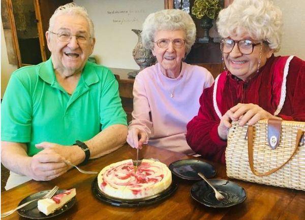 At LakePoint, August, KS (aka Shady Pines) Sophia visits with a couple and eats some cheesecake.   1