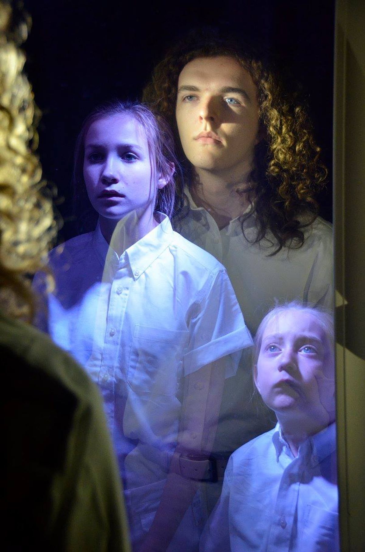 The actors playing Tommy in the Murfreesboro production of "The Who's Tommy:" The older Tommy (Andrew Clark) gazes into the mirror and see images of his past self (Sarah Oppmann, center, and Neva Redman).