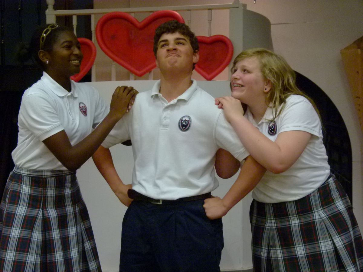 (L to R)
Danielle Russell (8th grader,) "Storyteller/Snow White", C J Romano (8th grader,) "Shrek," and Kirsten Hassinger (7th grader), "Storyteller/Cinderella" rehearse a scene from the upcoming production of Shrek The Musical JR.