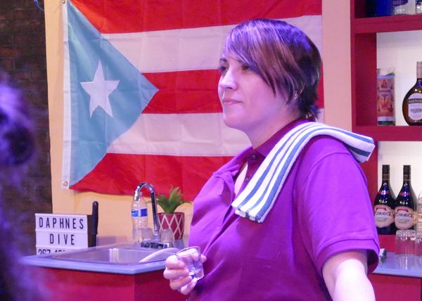 Daphne (Tannia Montes) a home in her bar, Daphne's Dive. 1