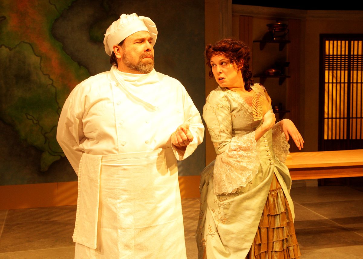 Casey Long as Guillaume and Chloe Gay Brewer as Madame Gagnier in the rolling world premiere of "Colonialism is Terrible, But Phở is Delicious," playing March 31 - April 30, 2023 at Better Aitken theater arts Center on the Cripe Stage. Written by Dustin H. Chinn; Directed by Oánh Nguyễn. Photo by Doug Catiller, True Image Studio. 