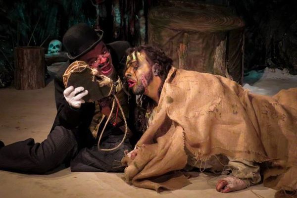 Stephano (Scott Hoffman) feeds Caliban (Tony Palmieri) his celestial liquor. 1