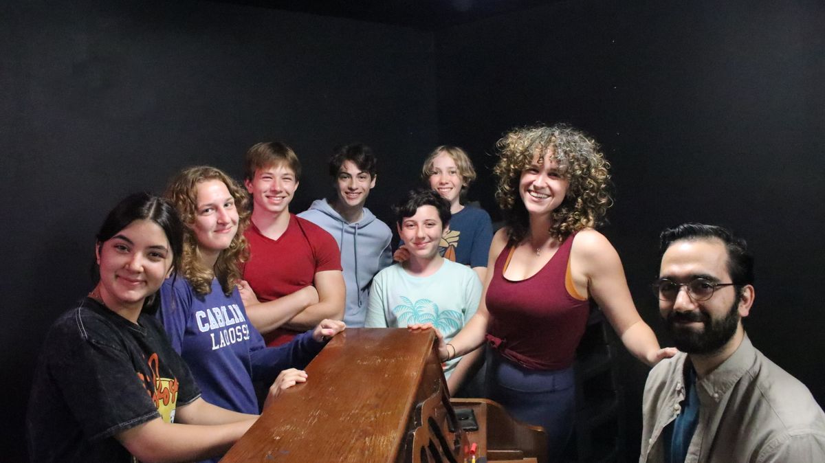 Directors take a break from rehearsal with some cast members.
