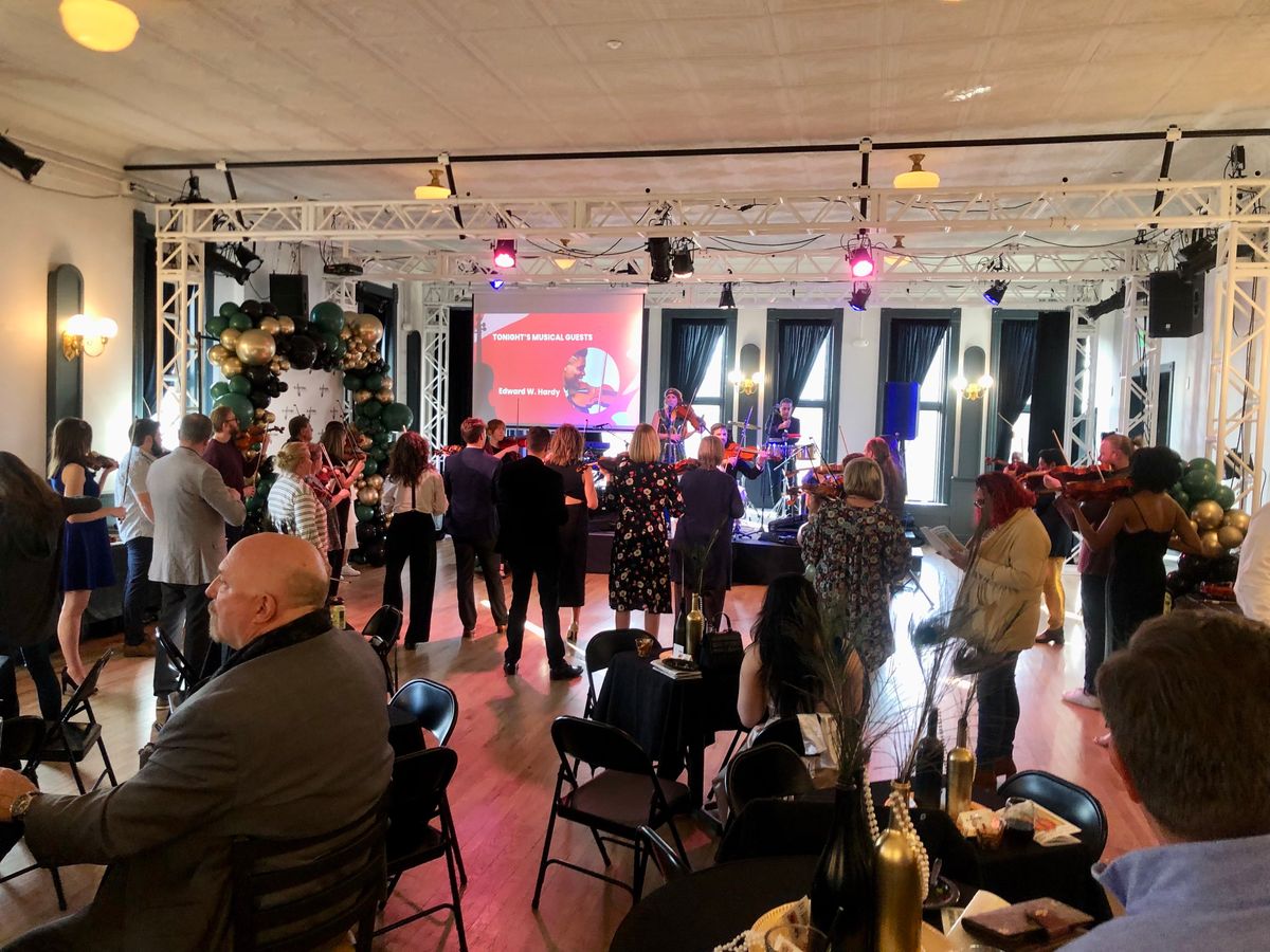 Adult violin students with Edward W. Hardy banner at El Sistema Colorado's 2023 Gala (The Savoy Denver). Adult violin students with Edward W. Hardy banner at El Sistema Colorado's 2023 Gala (The Savoy Denver).
