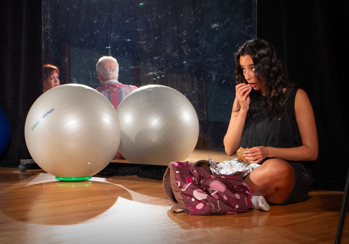 Lauren (Maya Grace Redington) eavesdrops on a conversation between Theresa (Kym Taylor) and James (Ben Ash) in Circle Mirror Transformation with The Shelburne Players.