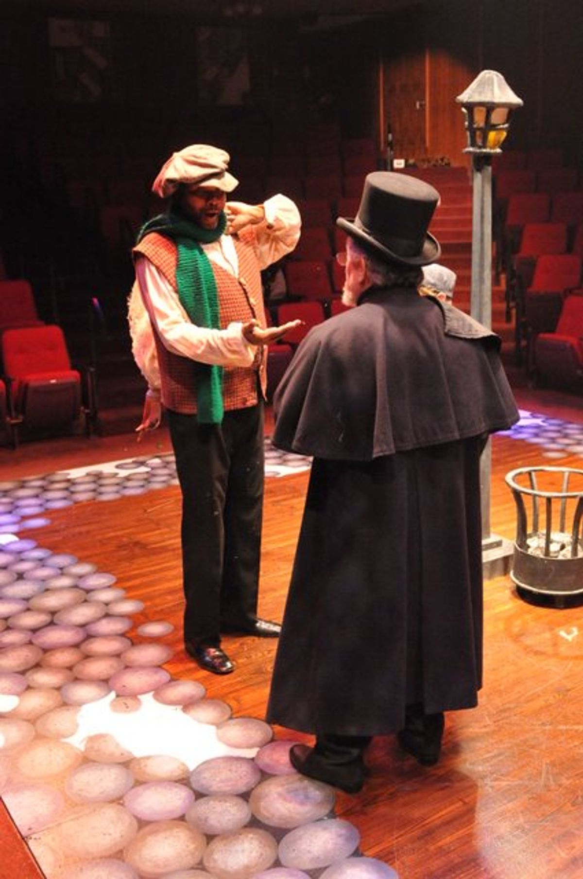 Payment Due Upon Delivery: Darryl Maximilian Robinson as The Poultry Man and Mario Di Gregorio as Ebenezer Scrooge in the 2010 Glendale Centre Theatre musical staging of A Christmas Carol.