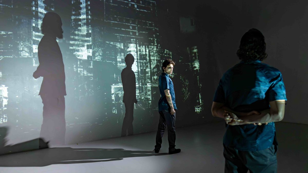 Aaron Greenberg and Ian Cramer in WE. Costume Design by Alyssa Korol. Projection Design by Matthew Deinhart. Photo by Jonathan Levin.