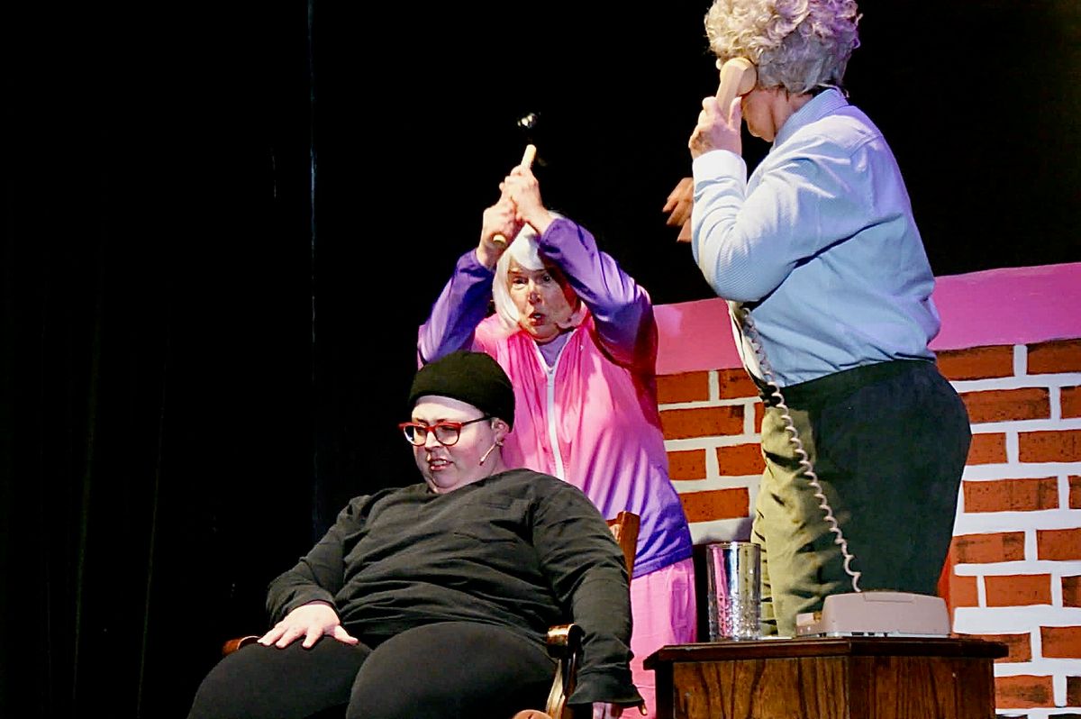 Violet (Judy Atkinson) and Mavis (Vivian Moller) use drastic measures to incapacitate Tug (Liz Atkinson, seated).