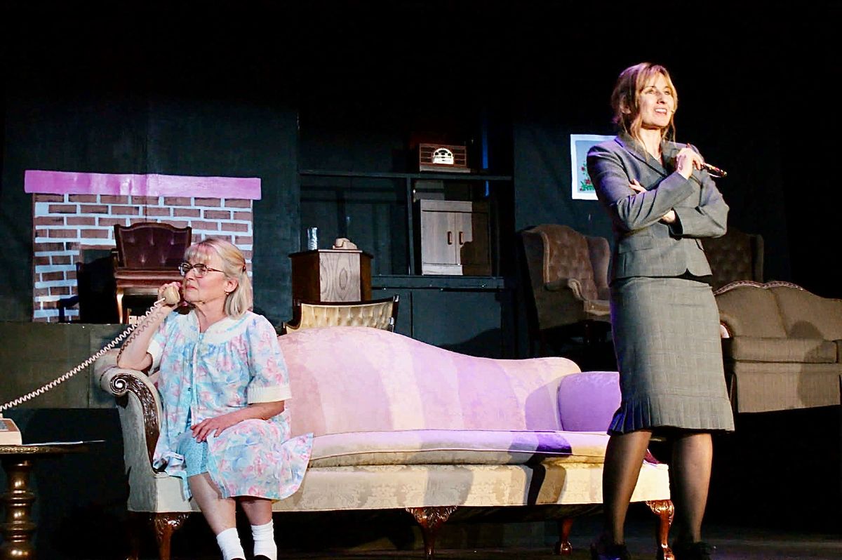 Lucy (Kelly Romel, standing) pauses the action to give a little backstory of the lives of her friends and neighbors.