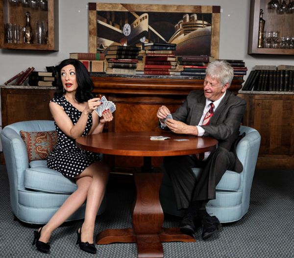 Heather Forte as Billie Dawn and Neil Kasanofsky as Harry Brock playing cards in Venice Theatre's production of Born Yesterday. 1